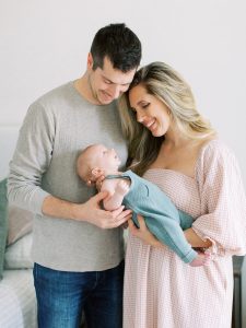 new parents look down at son during Charleston SC newborn session