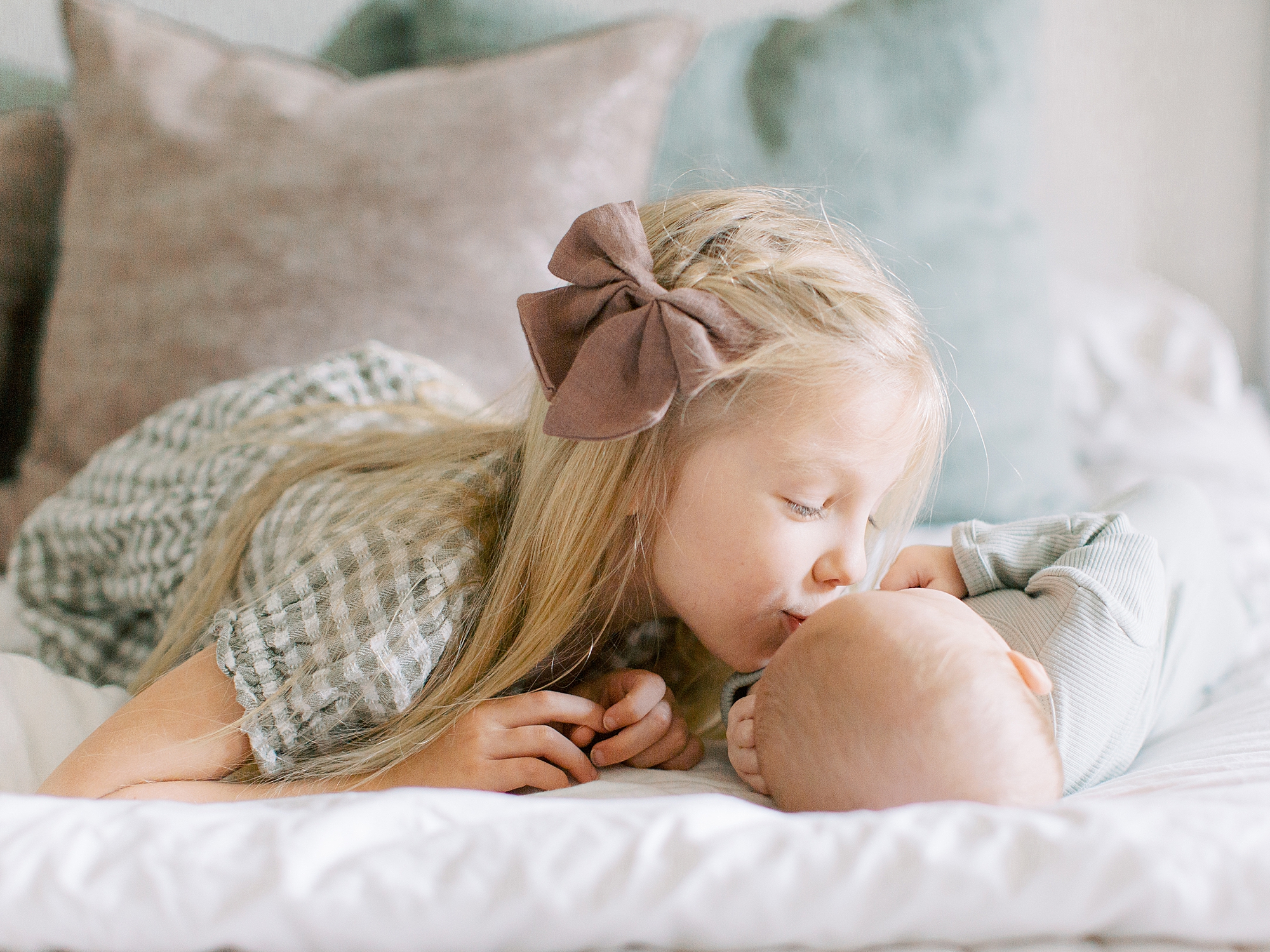 sister kisses new brother during Charleston SC newborn session