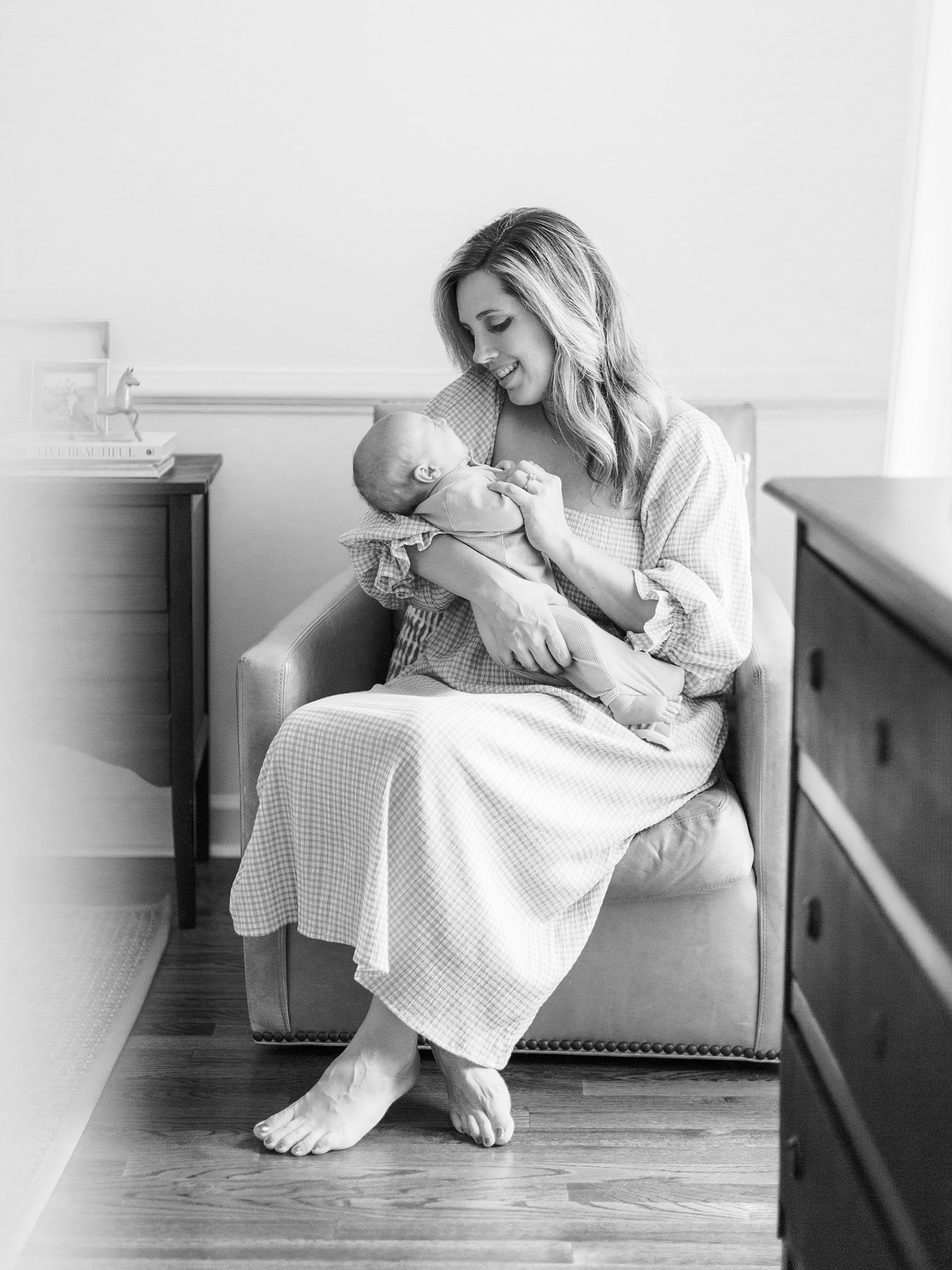 mom holds new son in nursery during lifestyle Charleston SC newborn session