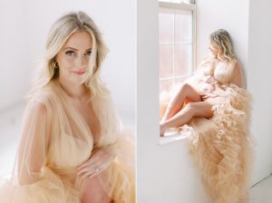 woman in peach maternity gown sits in window during studio maternity session
