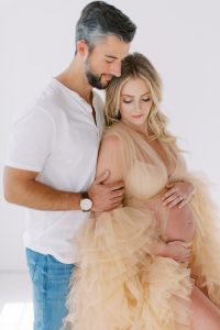 couple hugs in studio during maternity portraits