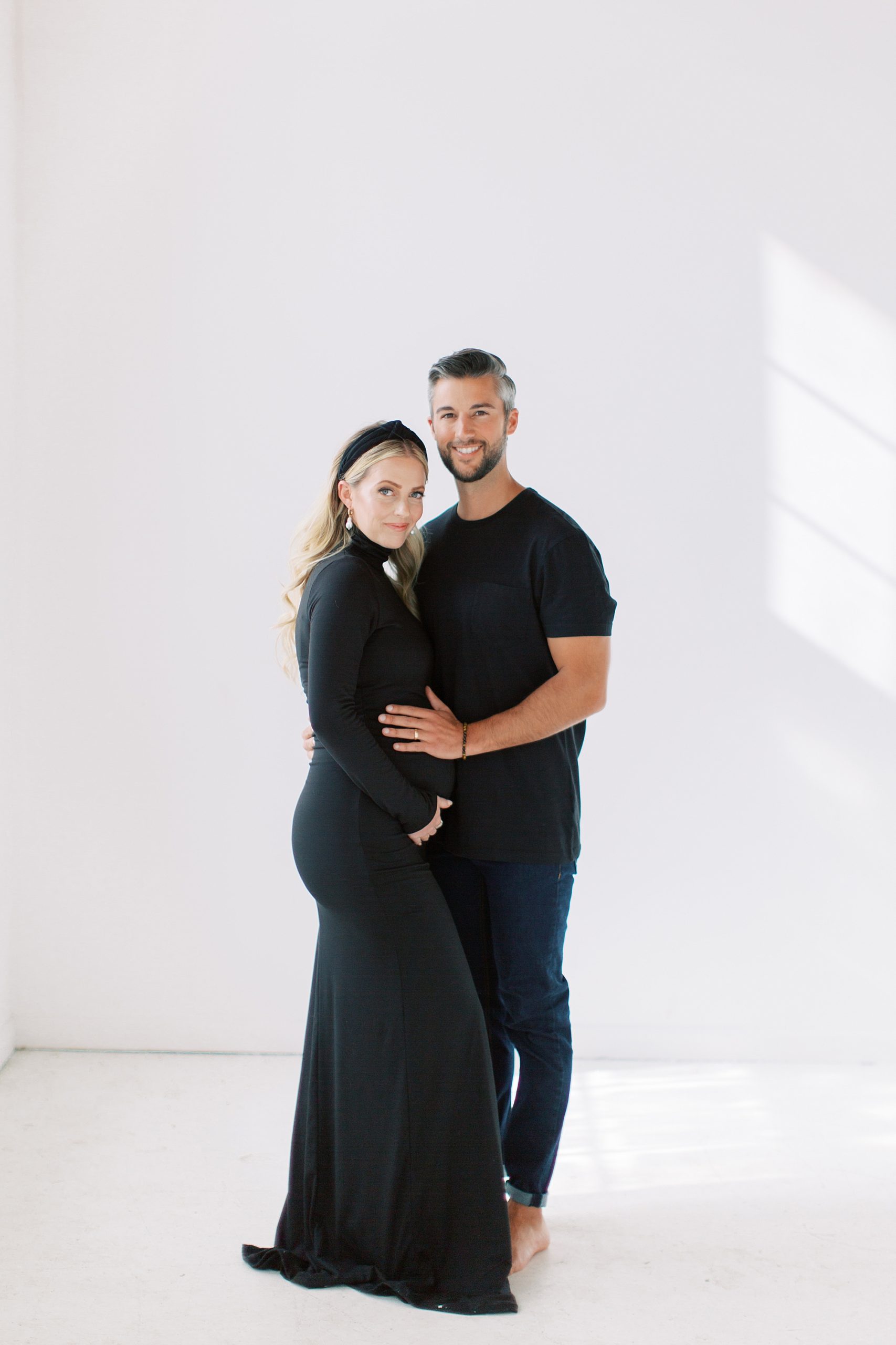 man and woman pose in Charlotte NC studio during maternity portraits