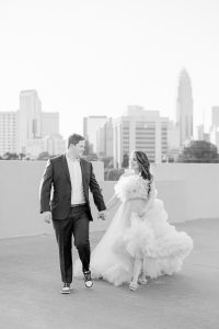 bride and groom walk on rooftop in Charlotte NC