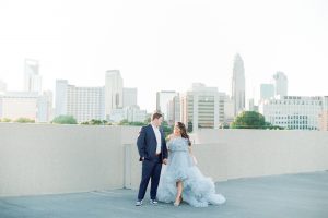 bride walks in blue dress for glam Charlotte engagement session