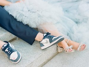 groom shows off shoes during glam Charlotte engagement session