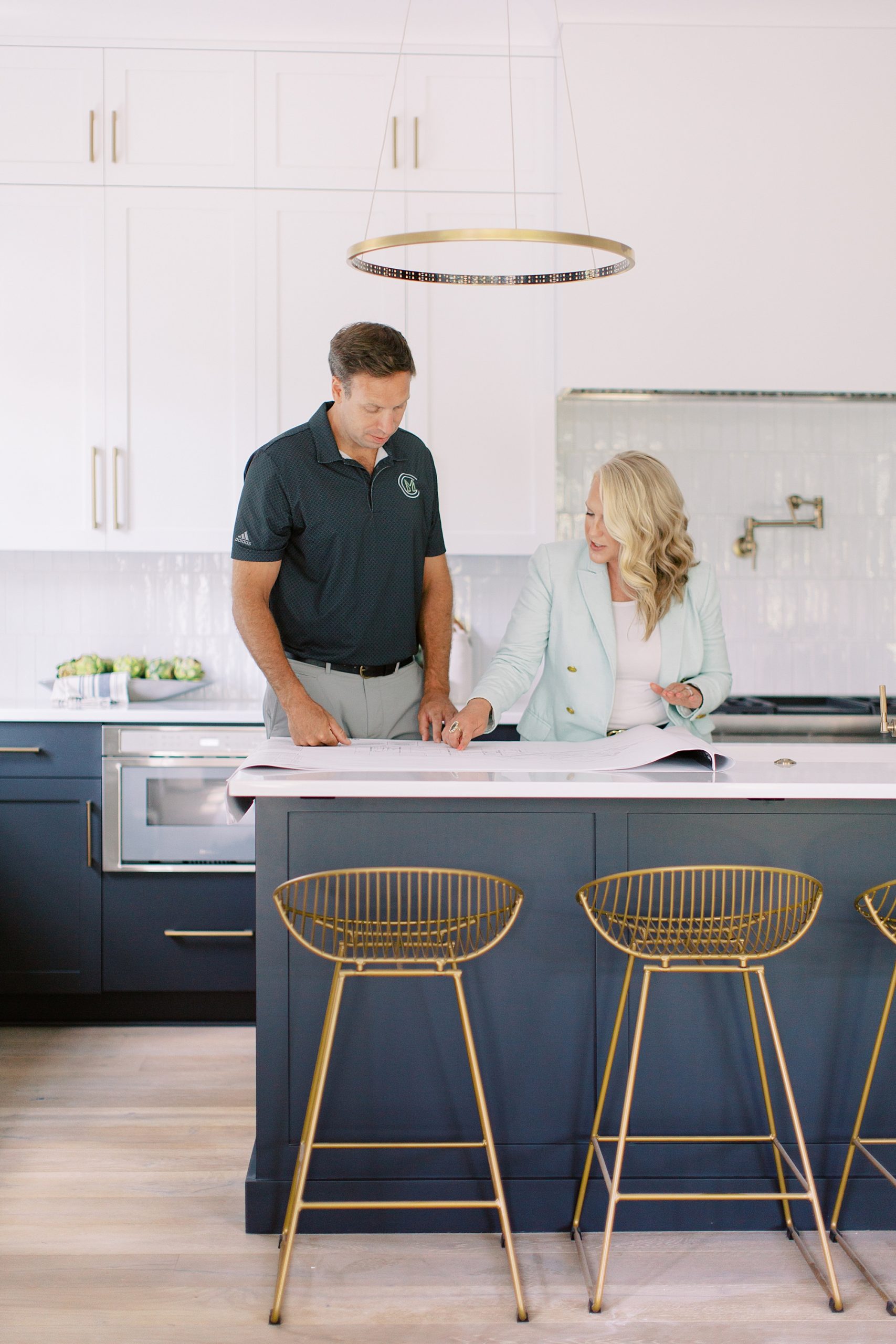 couple works at kitchen counter during Charlotte branding portraits for construction company