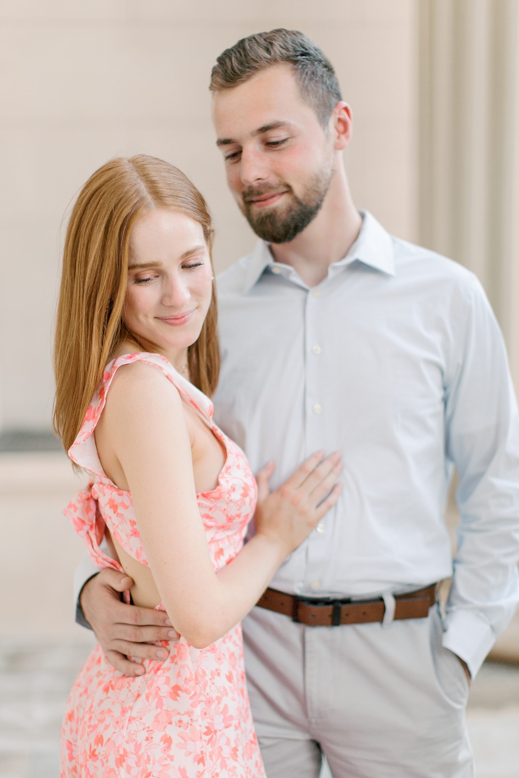 groom looks down at bride during portraits in Uptown Charlotte