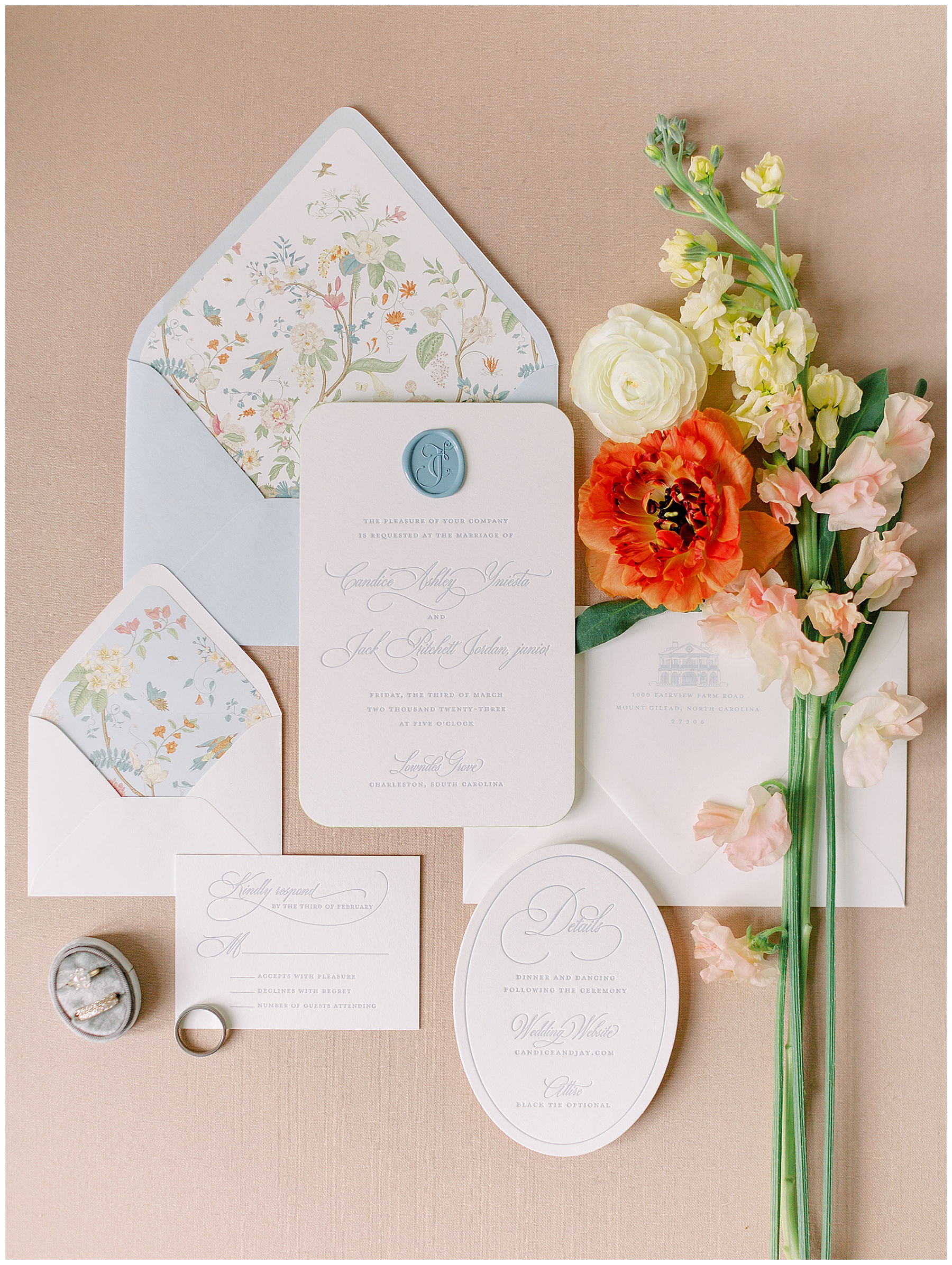 springtime wedding stationery with floral liner, blue wax seal, and blue calligraphy