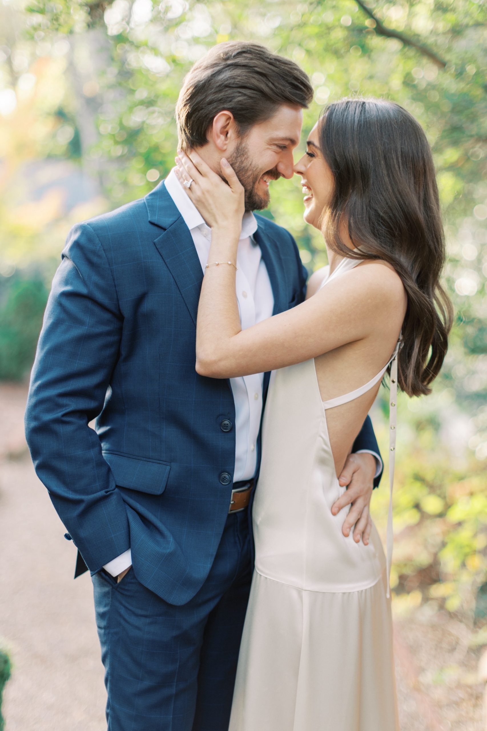 bride and groom hug in gardens of Duke Mansion in Charlotte NC