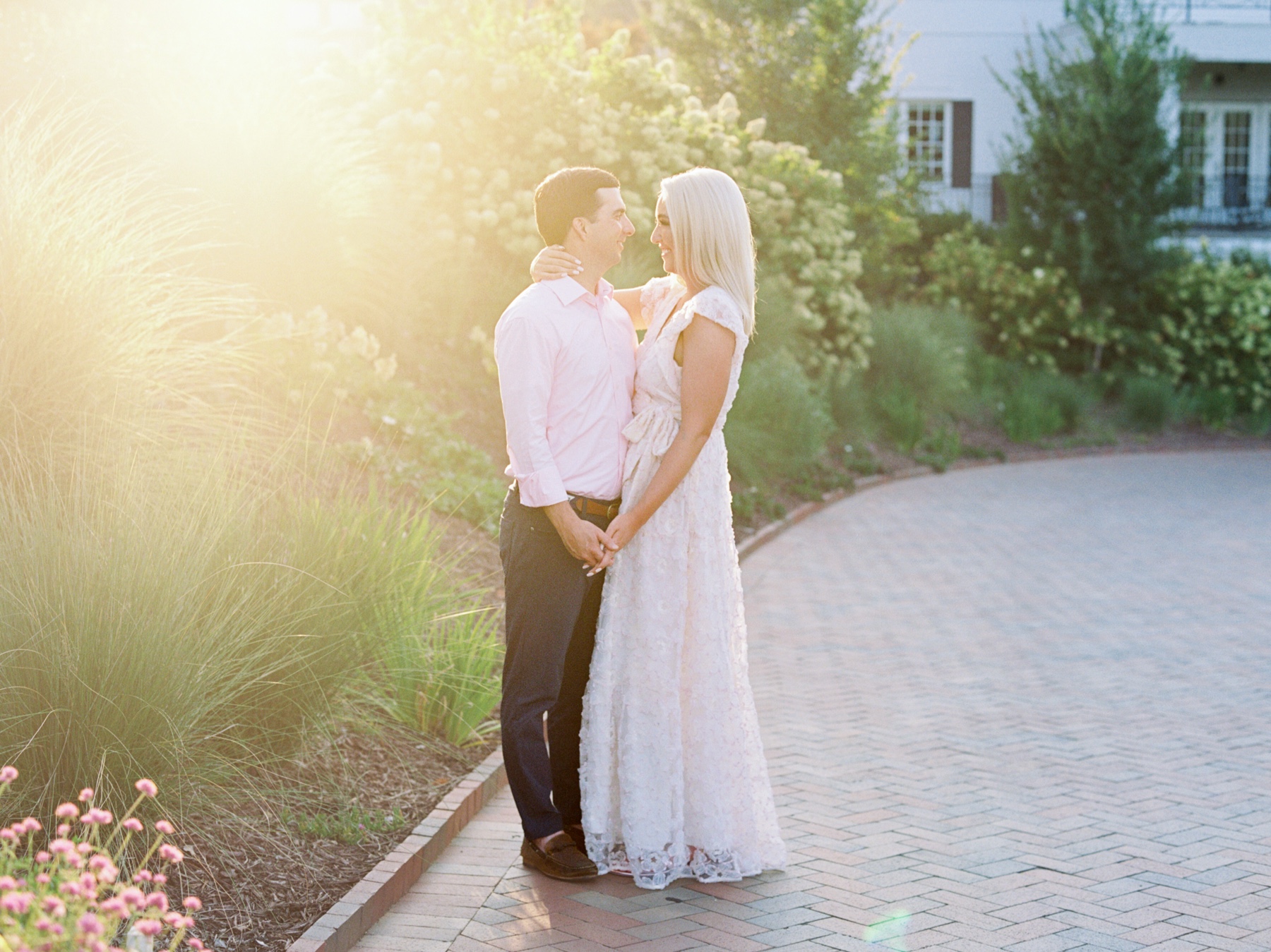man and woman face each other hugging on pathway in Charlotte NC