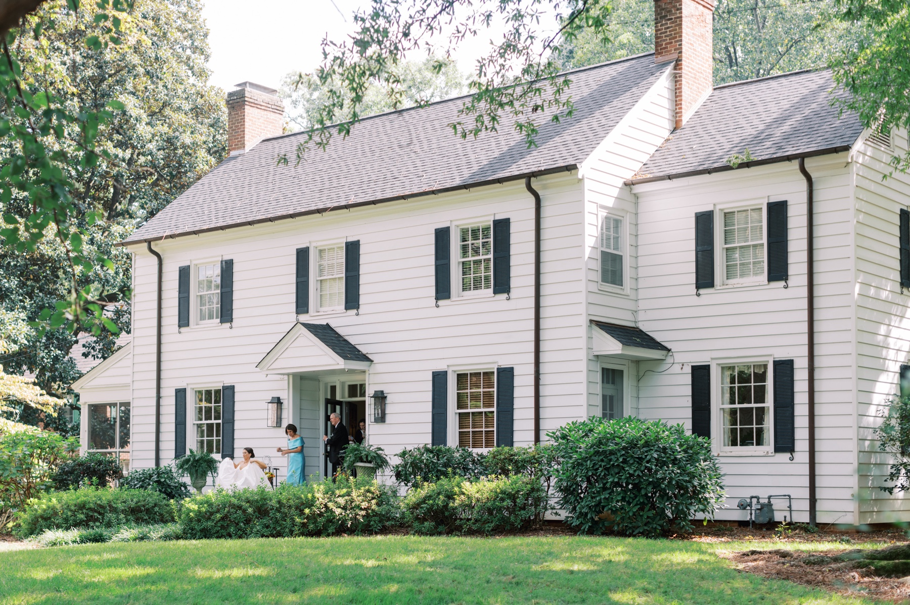 bride exits her childhood home where she readied for wedding day