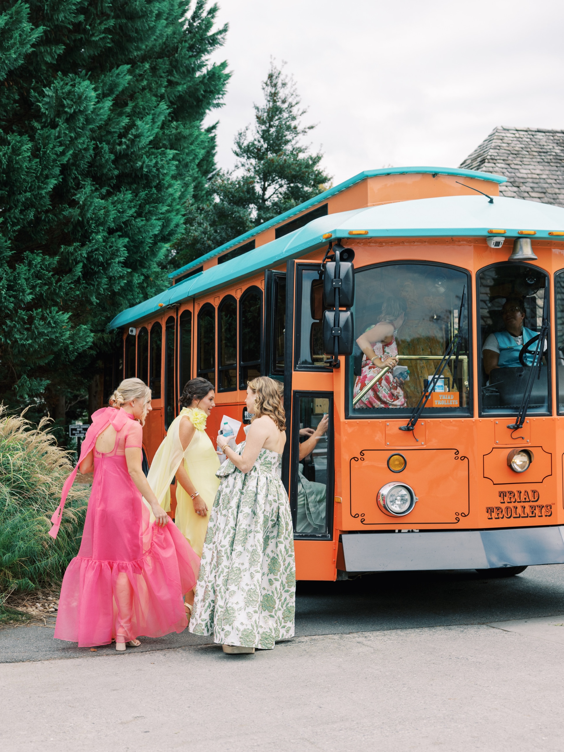 wedding party gets on bus to transport them to wedding