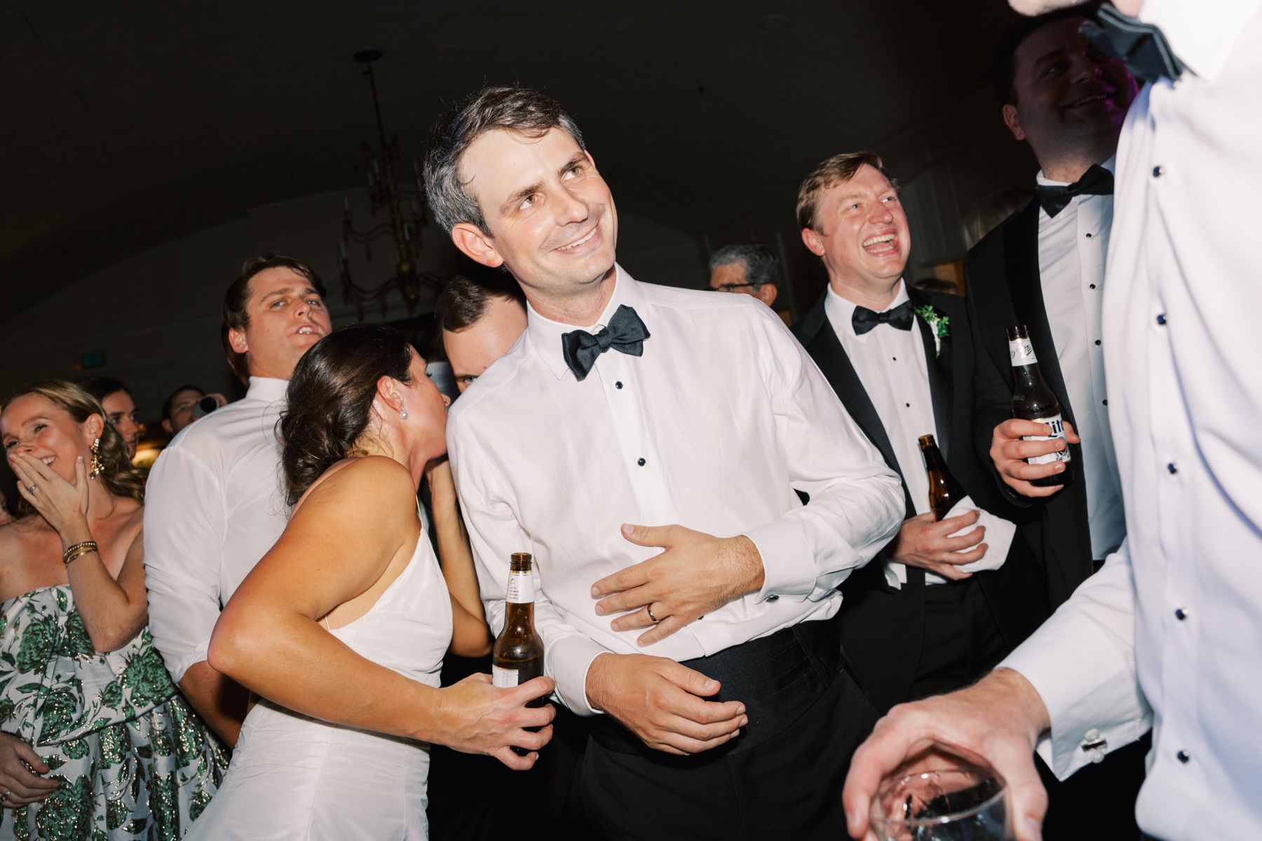 newlyweds on dance floor with loved ones
