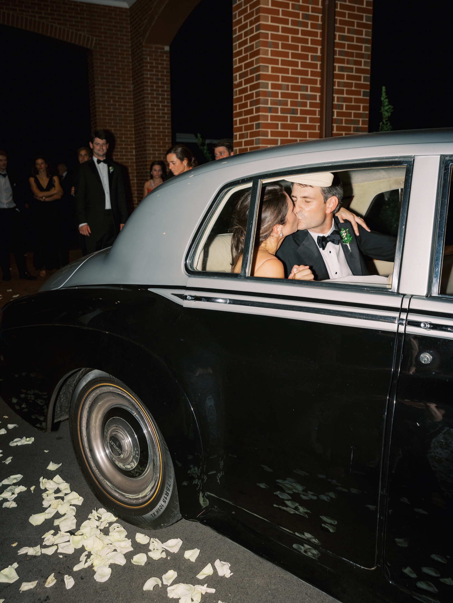 newlyweds kiss in getaway car after a Joyful, Stylish Wedding at Old Town Country Club in Winston-Salem