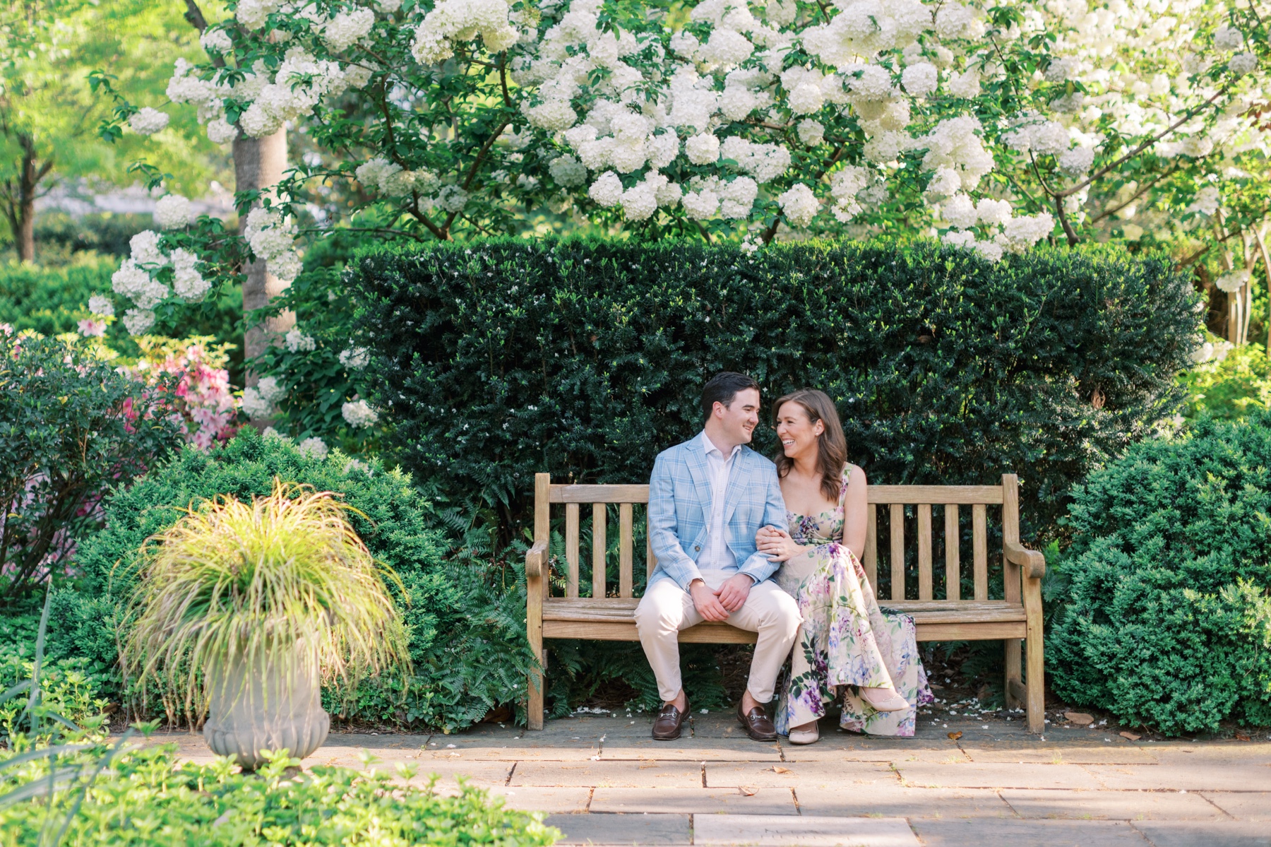 couple sit together on bench at Duke Mansion